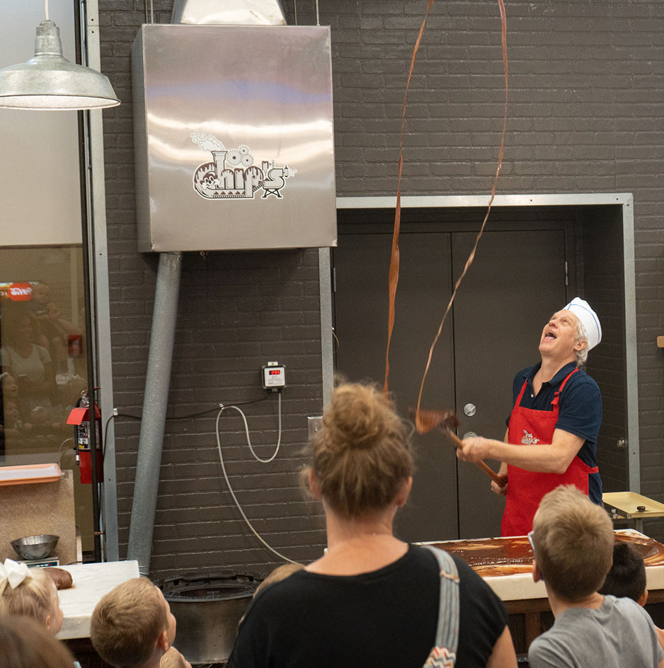 Chocolate factory instructor demonstrating to children